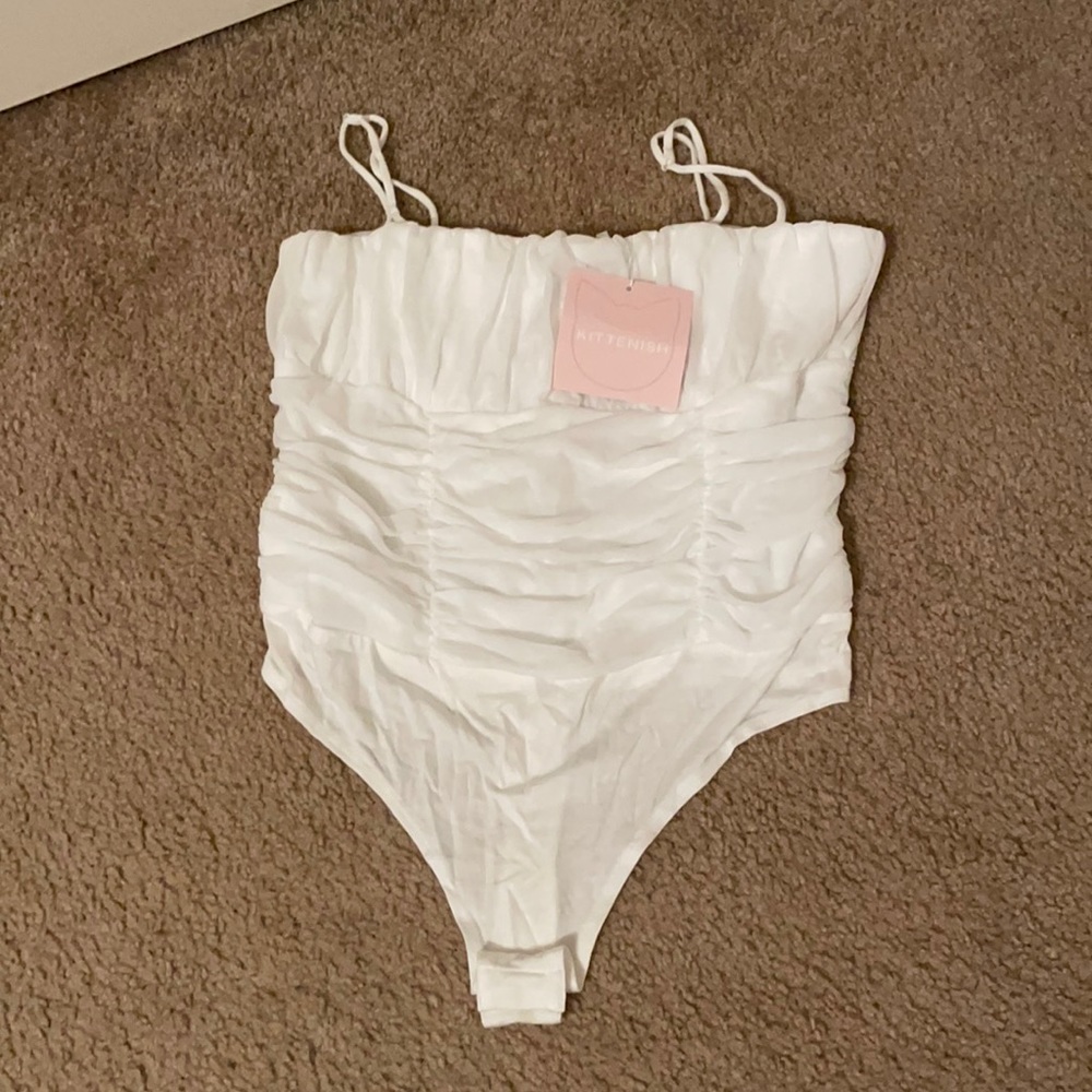 Kittenish white ruffled bodysuit